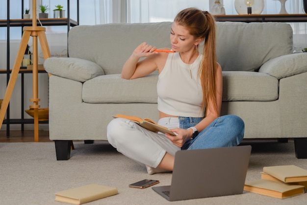 young student doing homework after lectures freelancer works at the computer