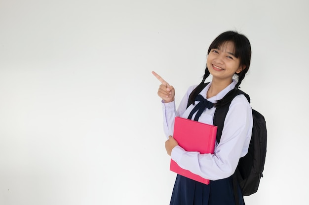 Young student girl hold pink book on white background