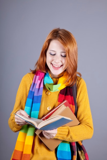 Young student girl with books. 