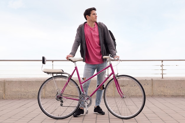 Young student holding a retro bike