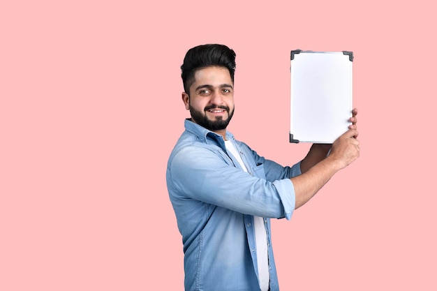 Young student is standing holding mini white board casual outfit indian pakistani model