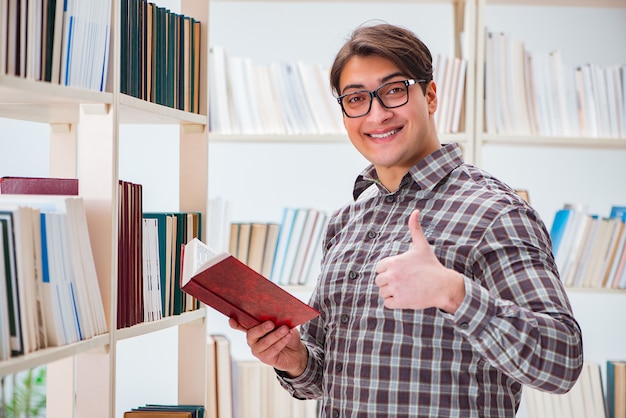 Young student looking for books in college library