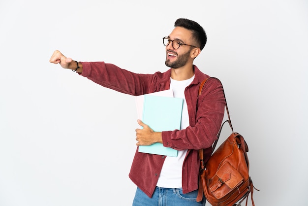 Young student man isolated on white background giving a thumbs up gesture