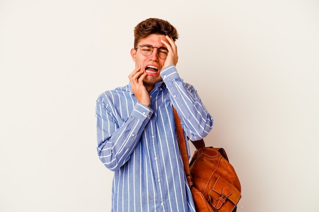 Young student man isolated on white background whining and crying disconsolately.