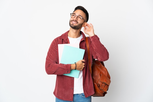 Young student man isolated on white wall having doubts