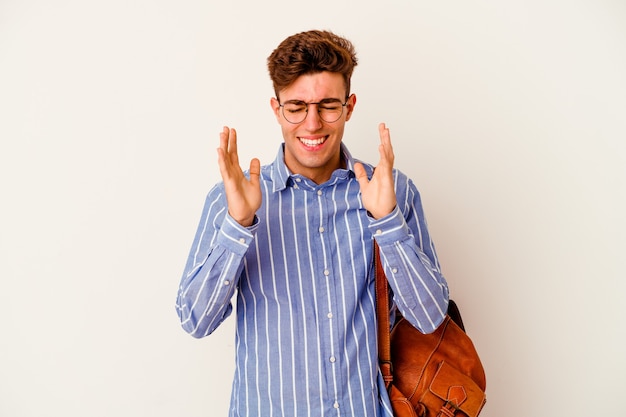 Young student man isolated on white wall joyful laughing a lot. Happiness concept.