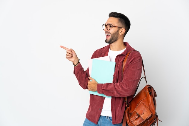 Young student man isolated on white wall pointing finger to the side and presenting a product