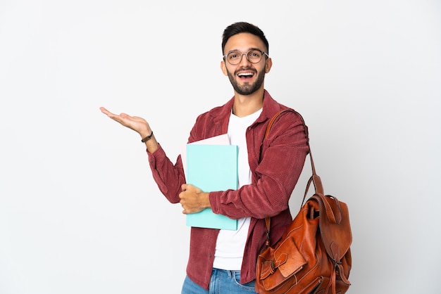 Young student man isolated xtending hands to the side for inviting to come