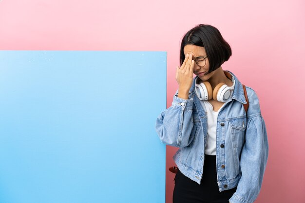 Young student mixed race woman with a big banner over isolated background with headache