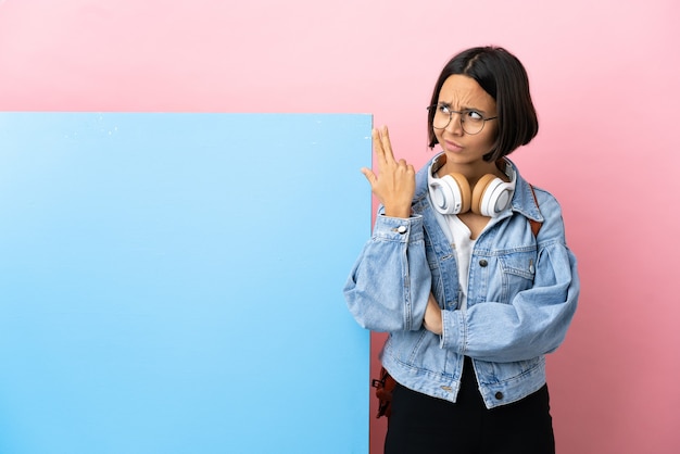 Young student mixed race woman with a big banner isolated