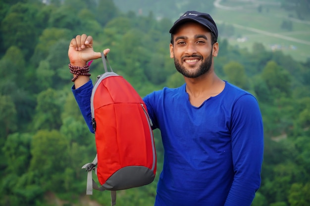 A young student showing his bag