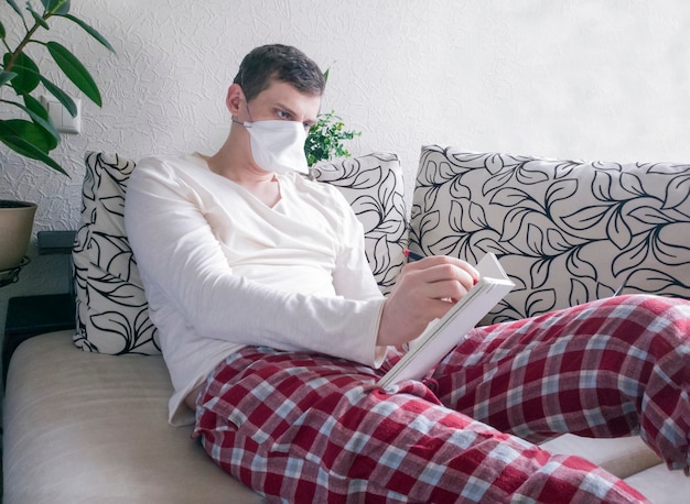 Young student wearing protective mask at home.