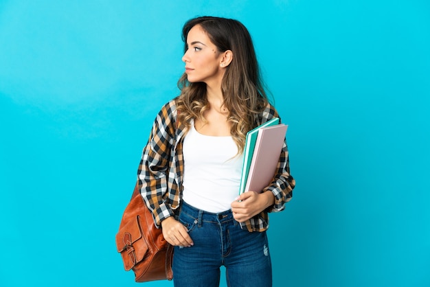 Young student woman isolated looking to the side