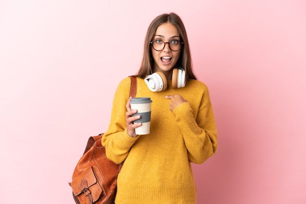 Young student woman over isolated pink background with surprise facial expression