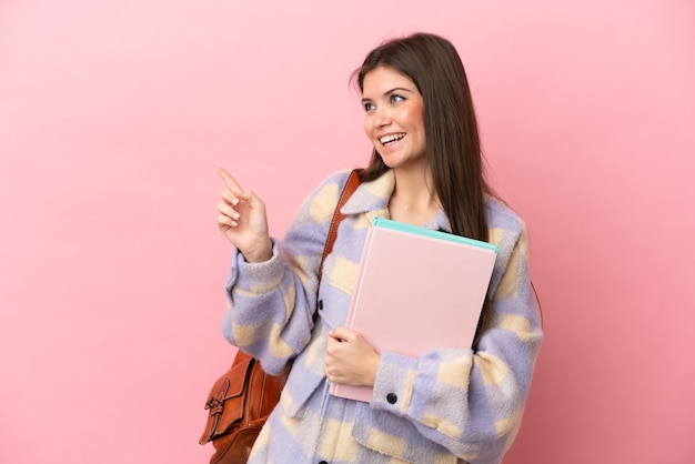 Young student woman isolated pointing finger to the side and presenting a product