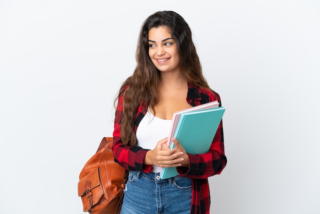 Young student woman isolated on white background thinking an idea while looking up