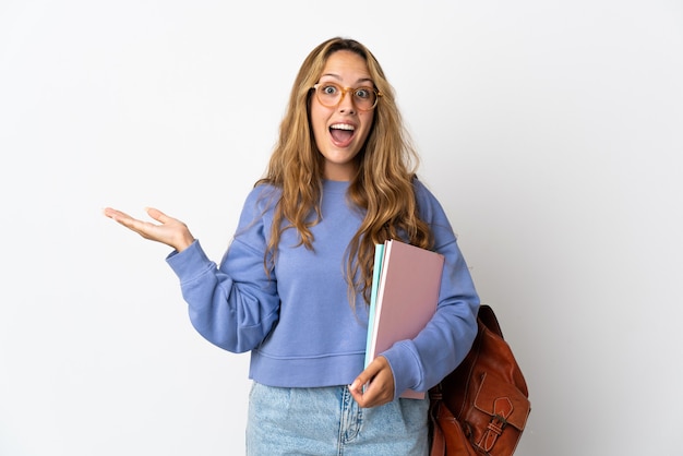 Young student woman isolated on white with shocked facial expression