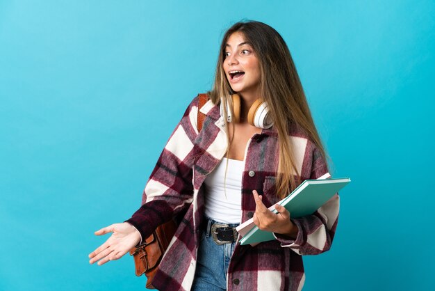 Young student woman isolated with surprise expression while looking side