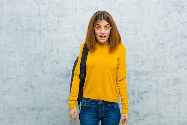 Young student woman looking very shocked