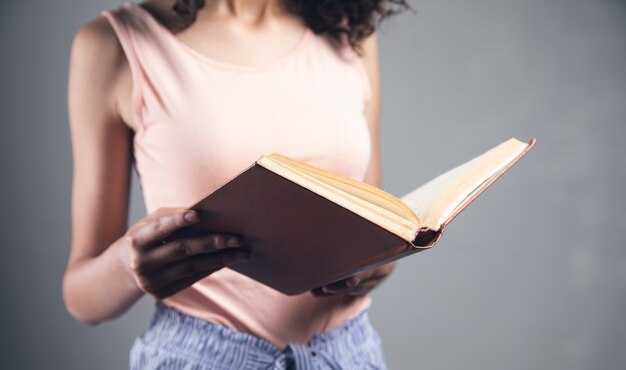 Young student woman reading a book.