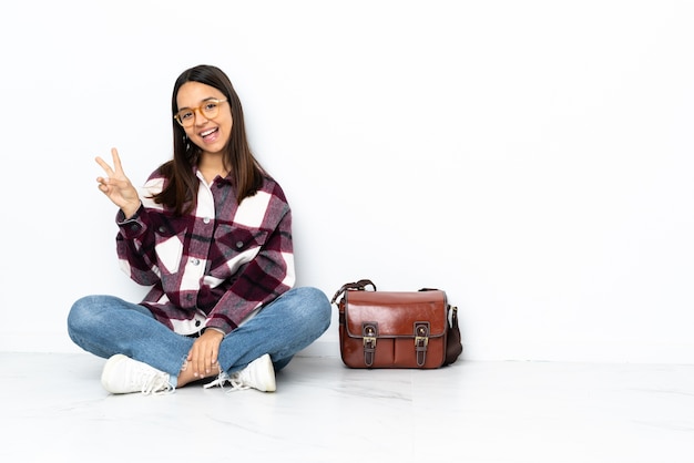 Young student woman sitting on the floor