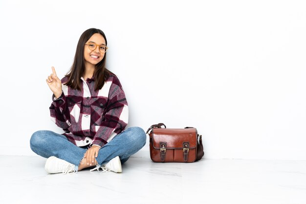 Young student woman sitting on the floor