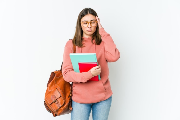 こめかみに触れて頭痛を持っている若い学生女性