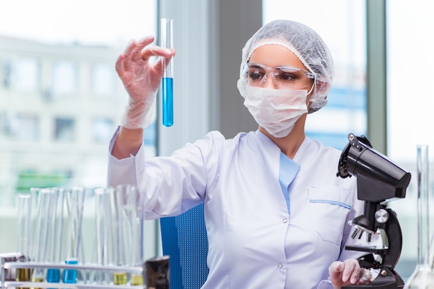 Young student working with chemical solutions in lab