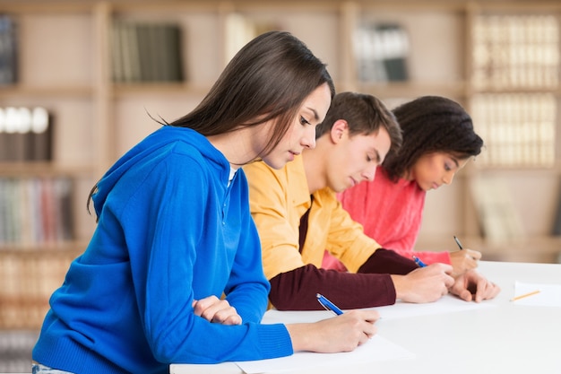 Young students studying on background