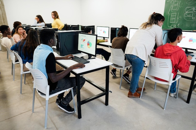 Young students using computers inside business class at school
- focus on african guy hand