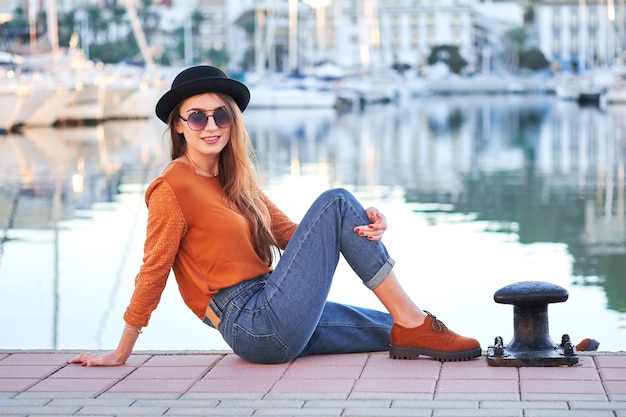 Young stylish girl in a sea port