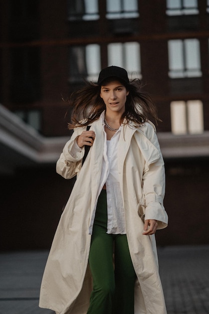 Young stylish girl on the street fashionable beautiful woman walking around the city high quality photo