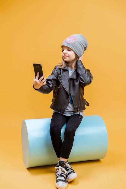 Young stylish girl taking selfie