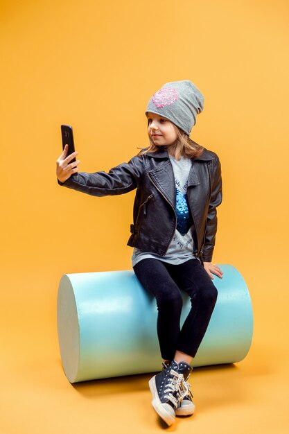 Young stylish girl taking selfie