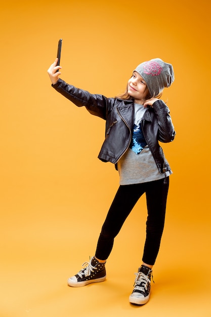 Young stylish girl taking selfie