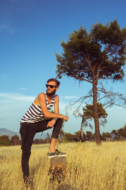 Young stylish handsome man in the savannah