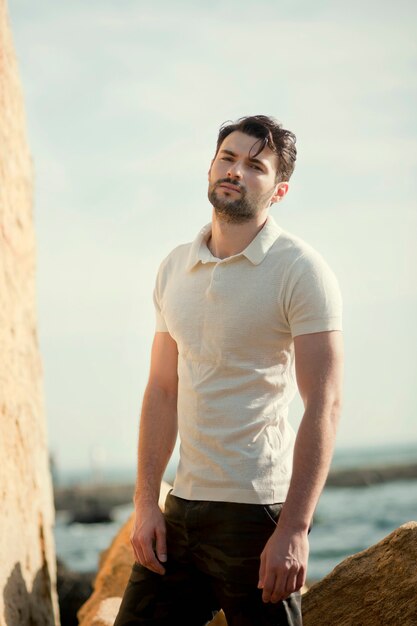 Young stylish man outdoor portrait, white polo shirt