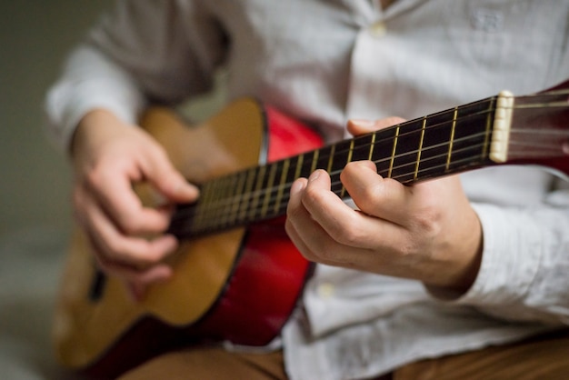 young stylish man playing guitar