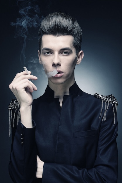 Young stylish man smoking a cigarette