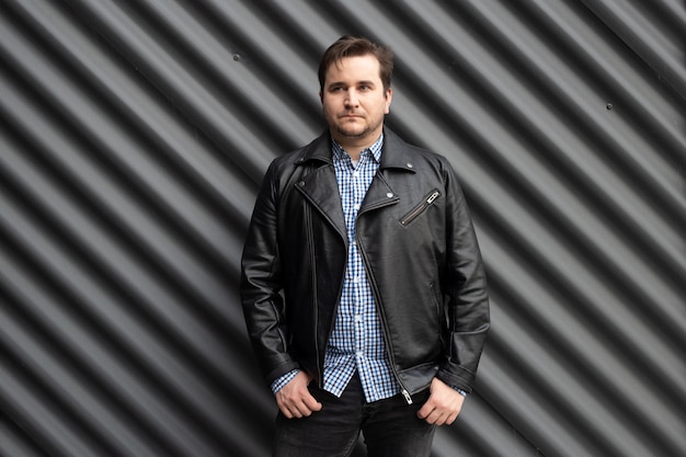 Young stylish man in urban wall