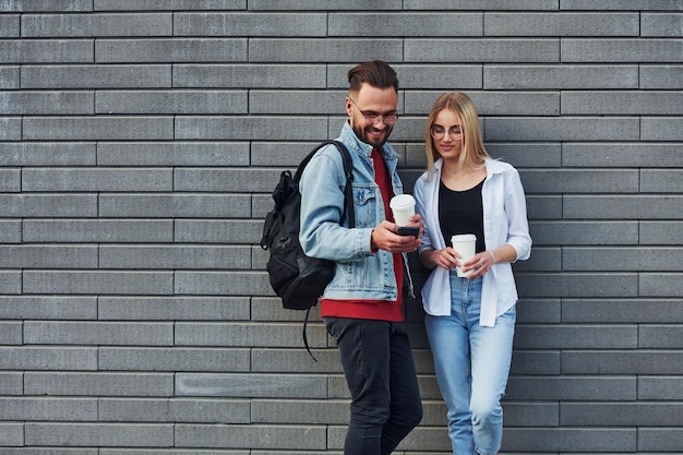 Young stylish man with woman in casual clothes outdoors together Conception of friendship or relationships