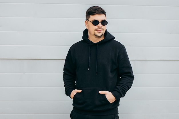 Young stylish men in glasses and black hoodie