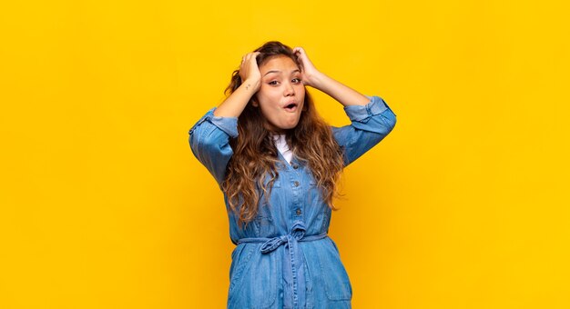 young stylish pretty woman on yellow background