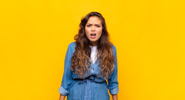 Young stylish pretty woman on yellow background