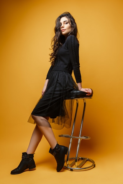 Young stylish woman on chair