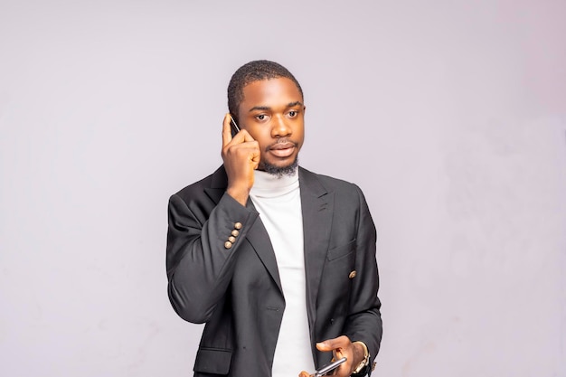 Young Successful black Business Man Talking Cell Phone isolated on a white studio background