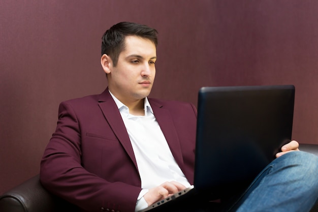 Young successful businessman with a laptop in hand.