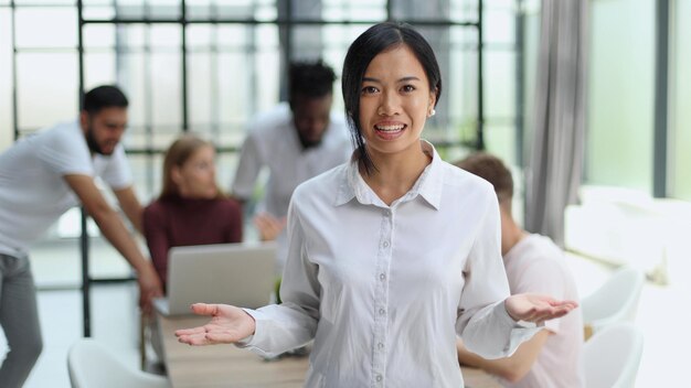 Young successful businesswoman in white shirt smiling