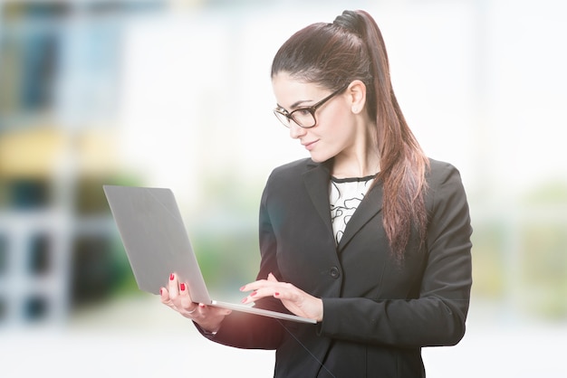 Young successful career woman holds her laptop