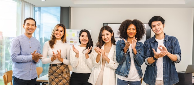 Young and successful mixed race diverse colleagues working on project together looking at camera friendship cooperation concept